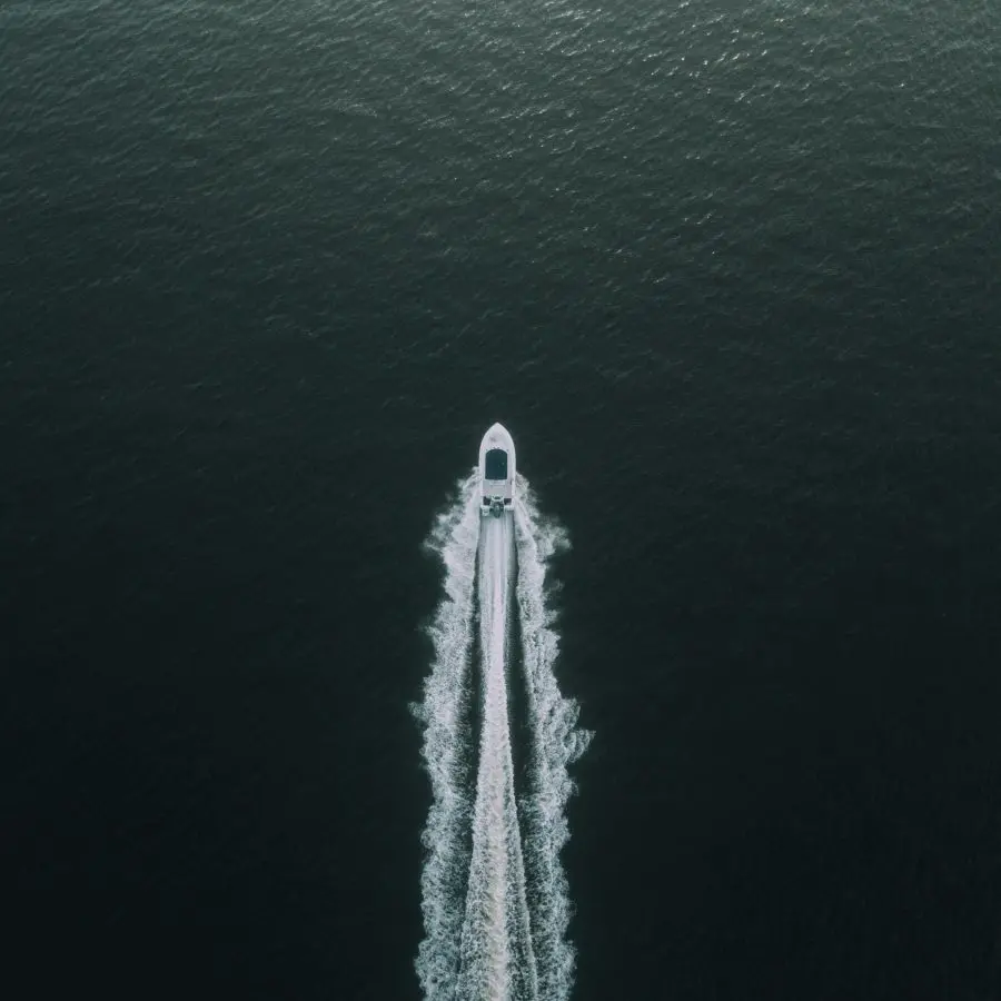 An aerial view of a speed boat on a lake