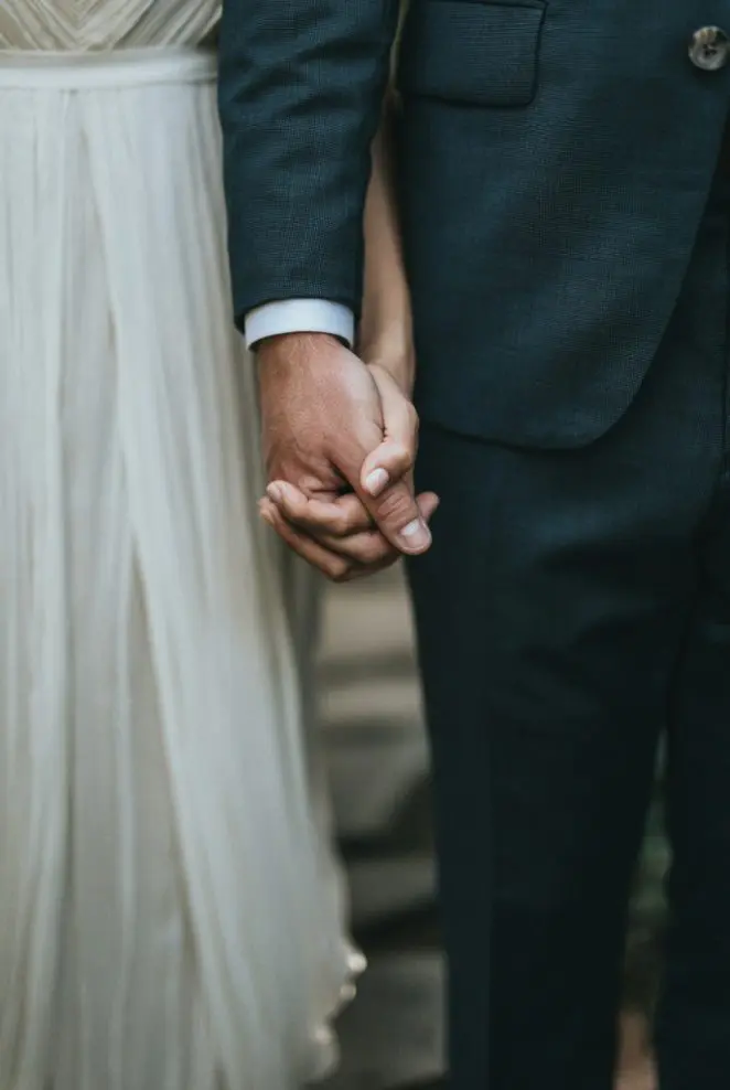 A man and woman holding hands