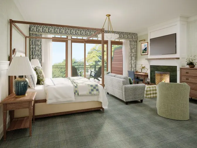 A suite with a fireplace and seating area
