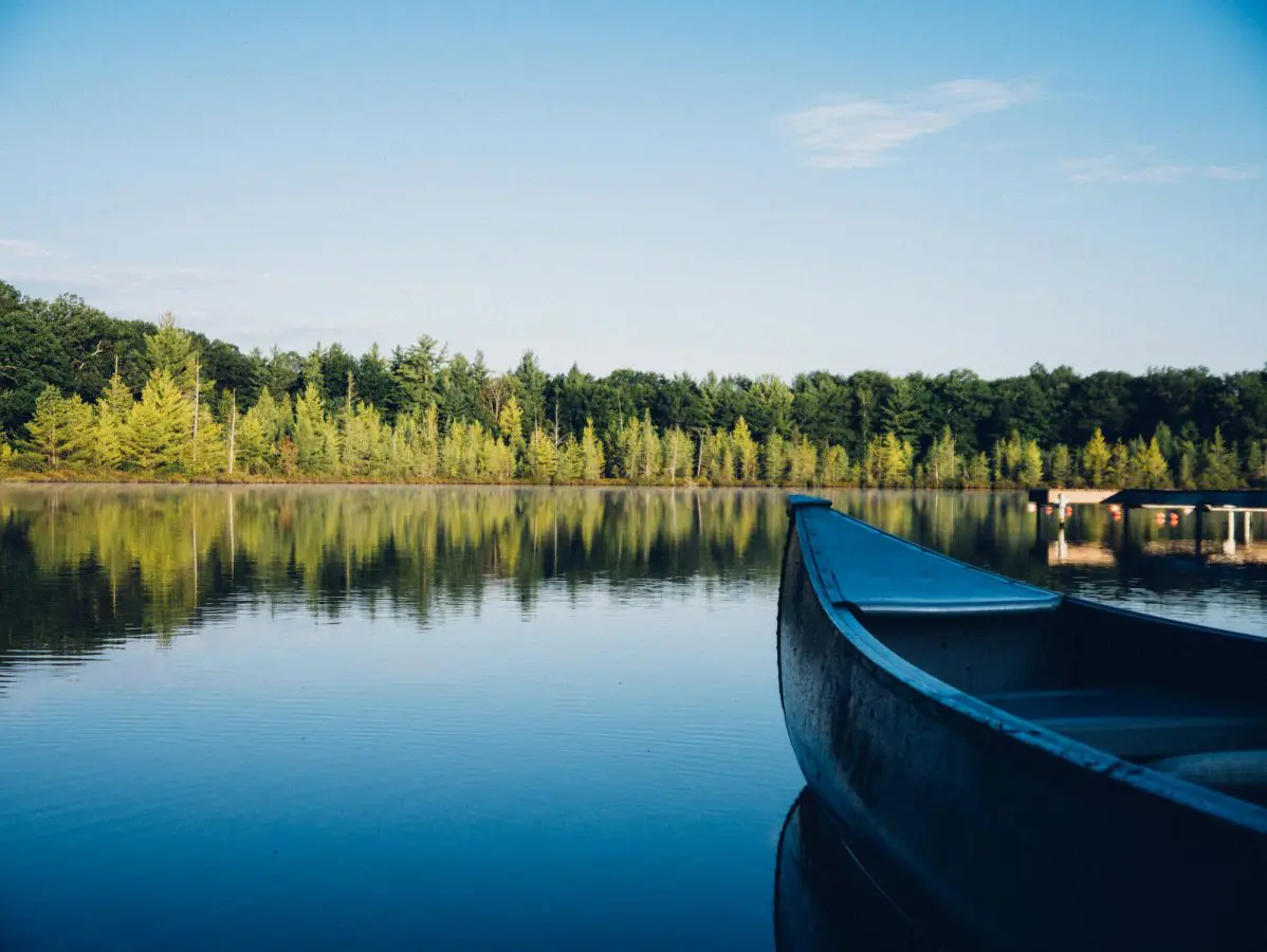 A canoe on a lake surrounded by trees