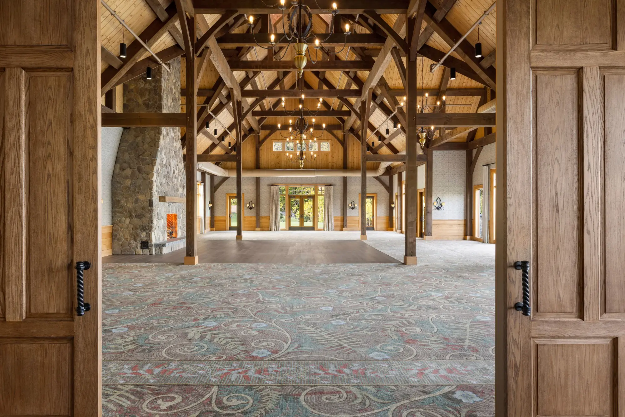 Expansive ballroom with chandeliers and fireplace