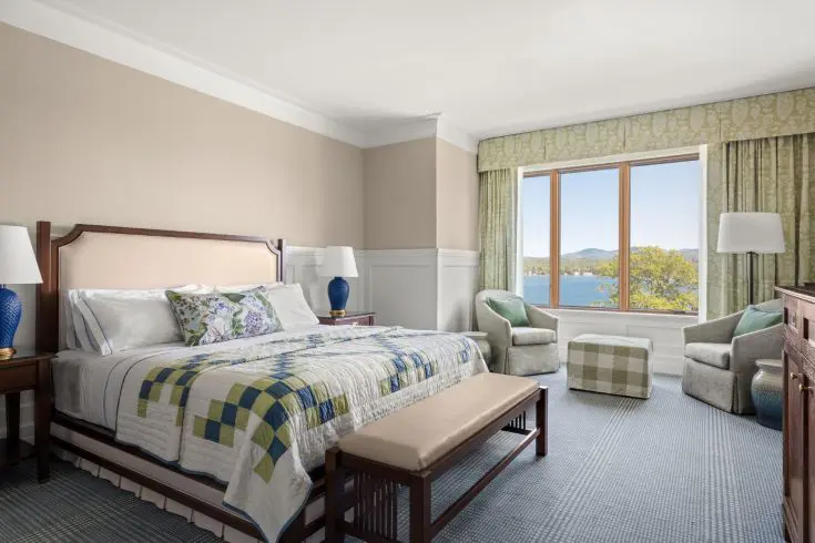 King guest room with lake view window and seating