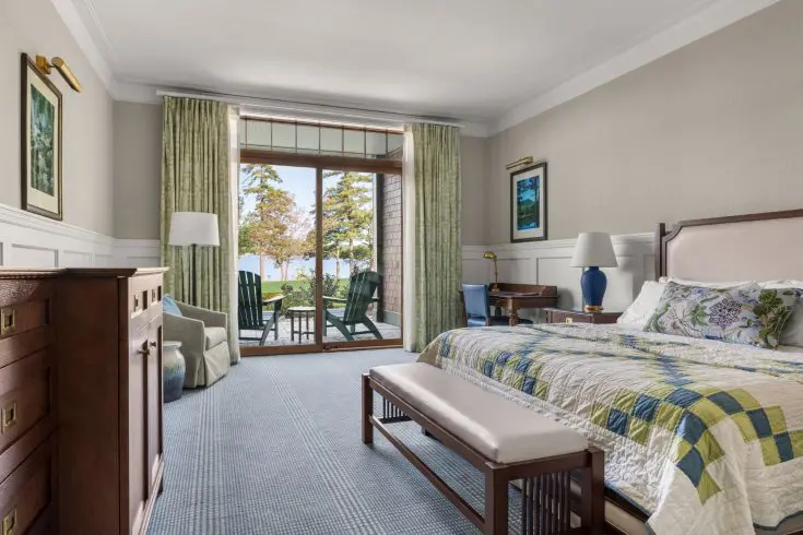 King guest room with patio seating and lake view
