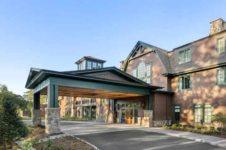 Hotel entrance with covered portico and stone pillars