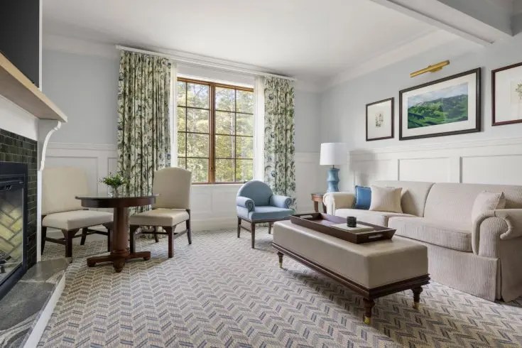 Suite living room with sofa, chairs and fireplace