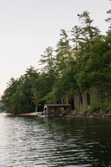 Shoreline boathouse at The Lake Estate, wooded view.