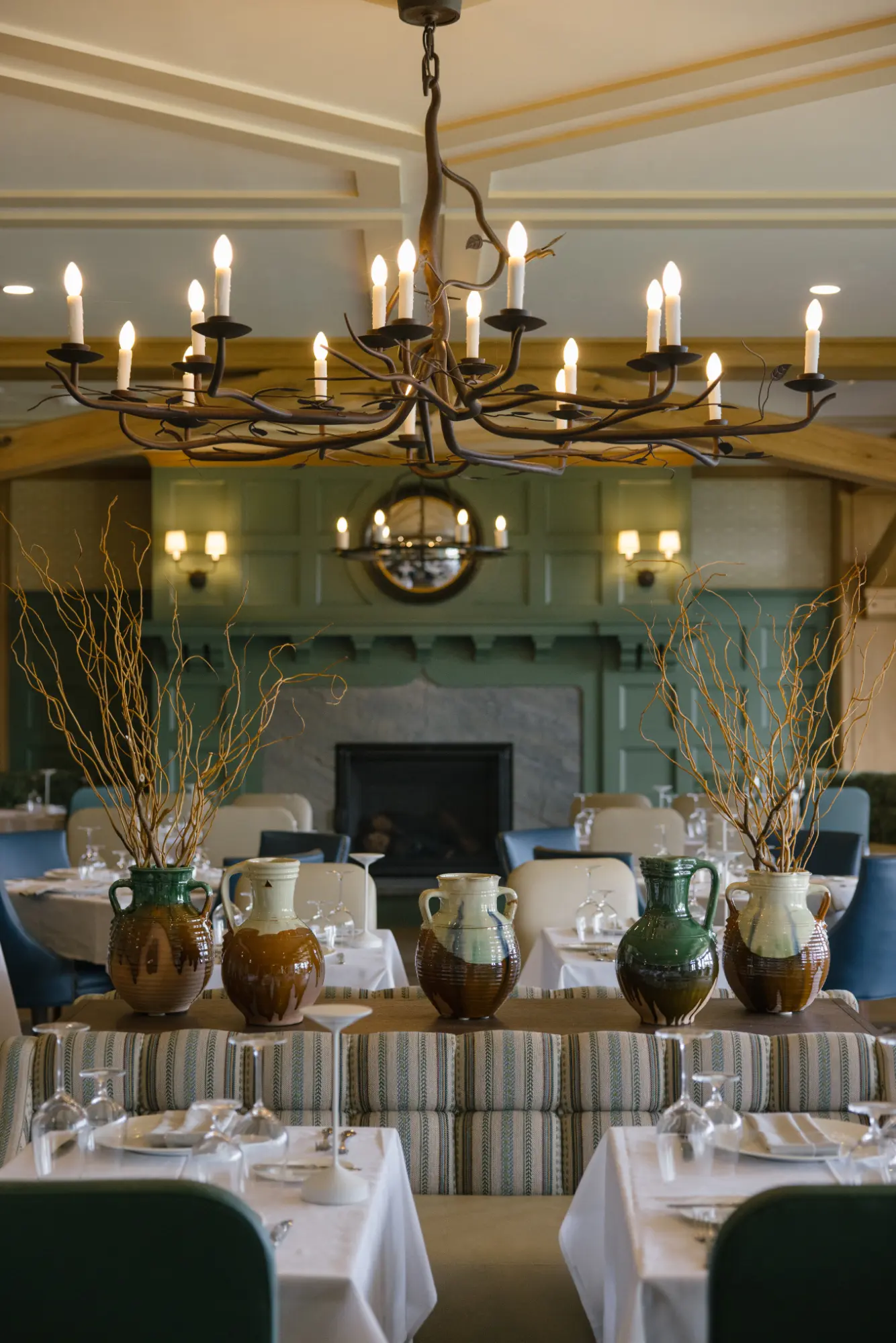 erinmcginn_TLE_FW25_0069 Elegant dining room with chandelier and fireplace view.