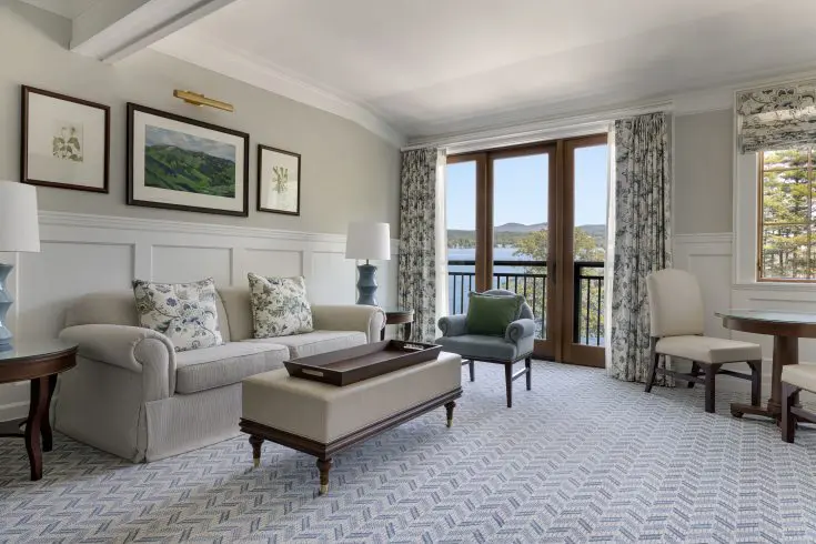 Lakeview suite featuring spacious living accommodations, a private balcony, and scenic views