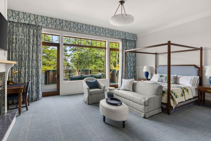 Spacious suite with canopy bed and balcony seating