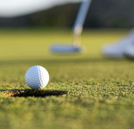 A golf putter and golf ball